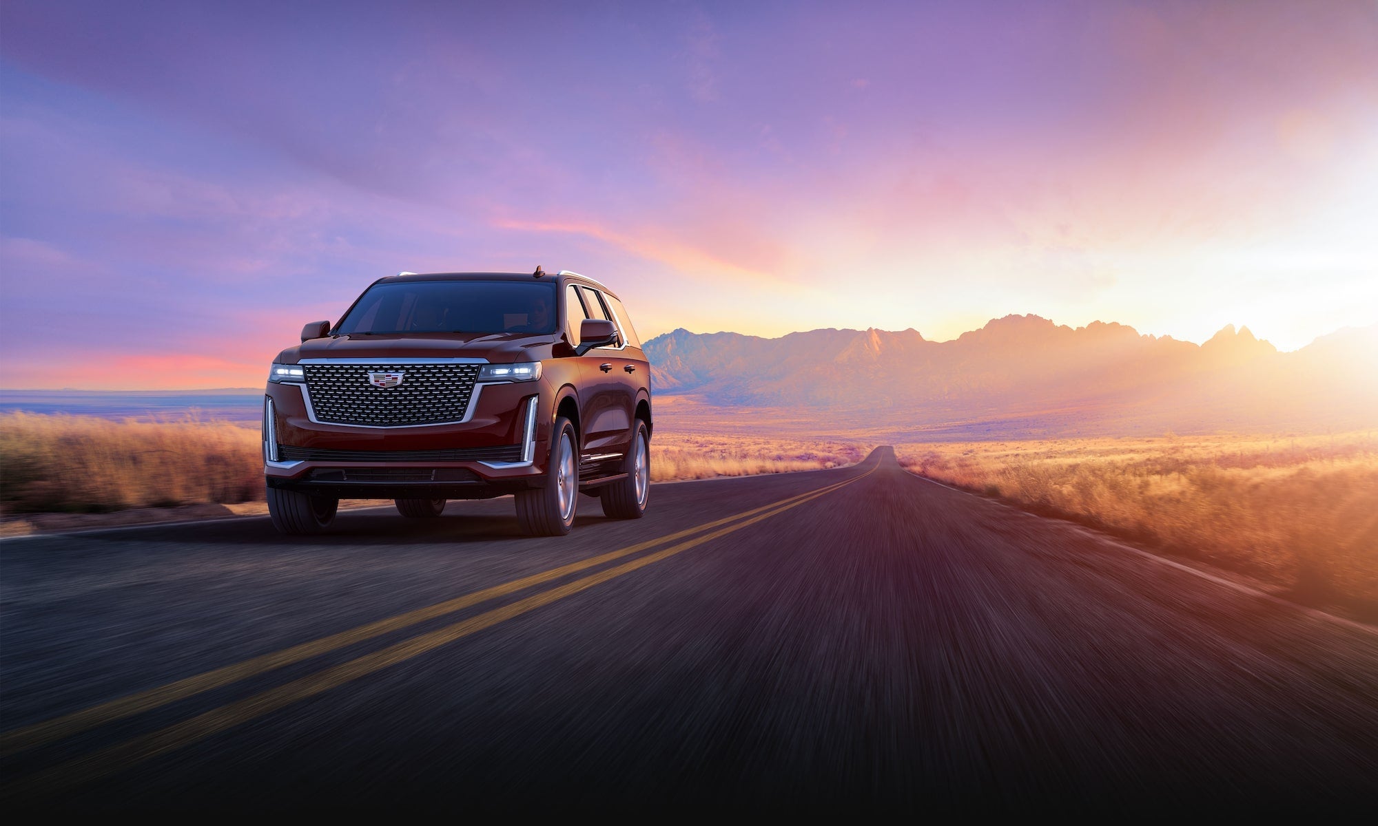 Cadillac Escalade driving on the road - Tom Clark Cadillac in Denton TX