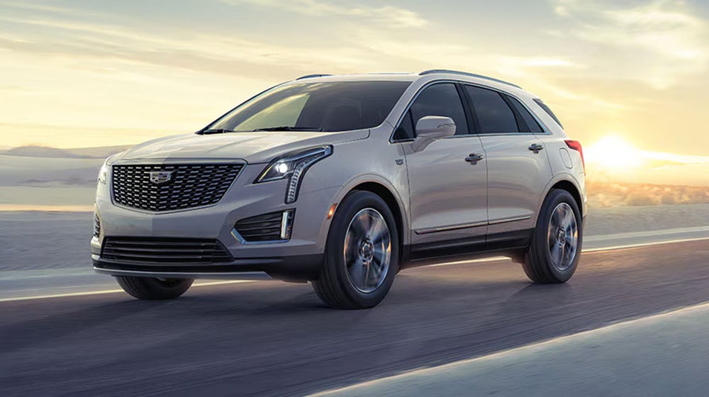 Cadillac driving down the road - Tom Clark Cadillac in Denton TX