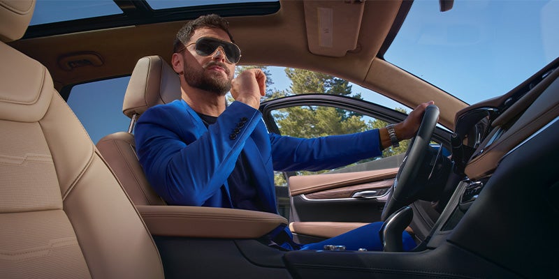 A guy driving their 2024 Cadillac XT5 - Tom Clark Cadillac in Denton TX