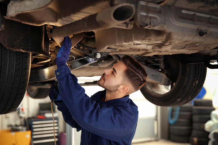 Service technician working on a car - Tom Clark Cadillac in Denton TX